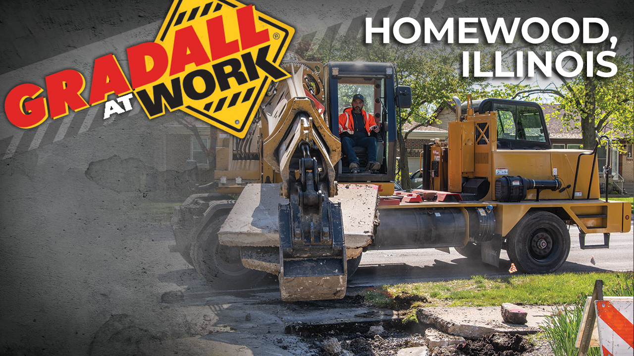 Highway speed wheeled excavator's powerful and precise boom movements demolish and remove curbs, gutters and sidewalks